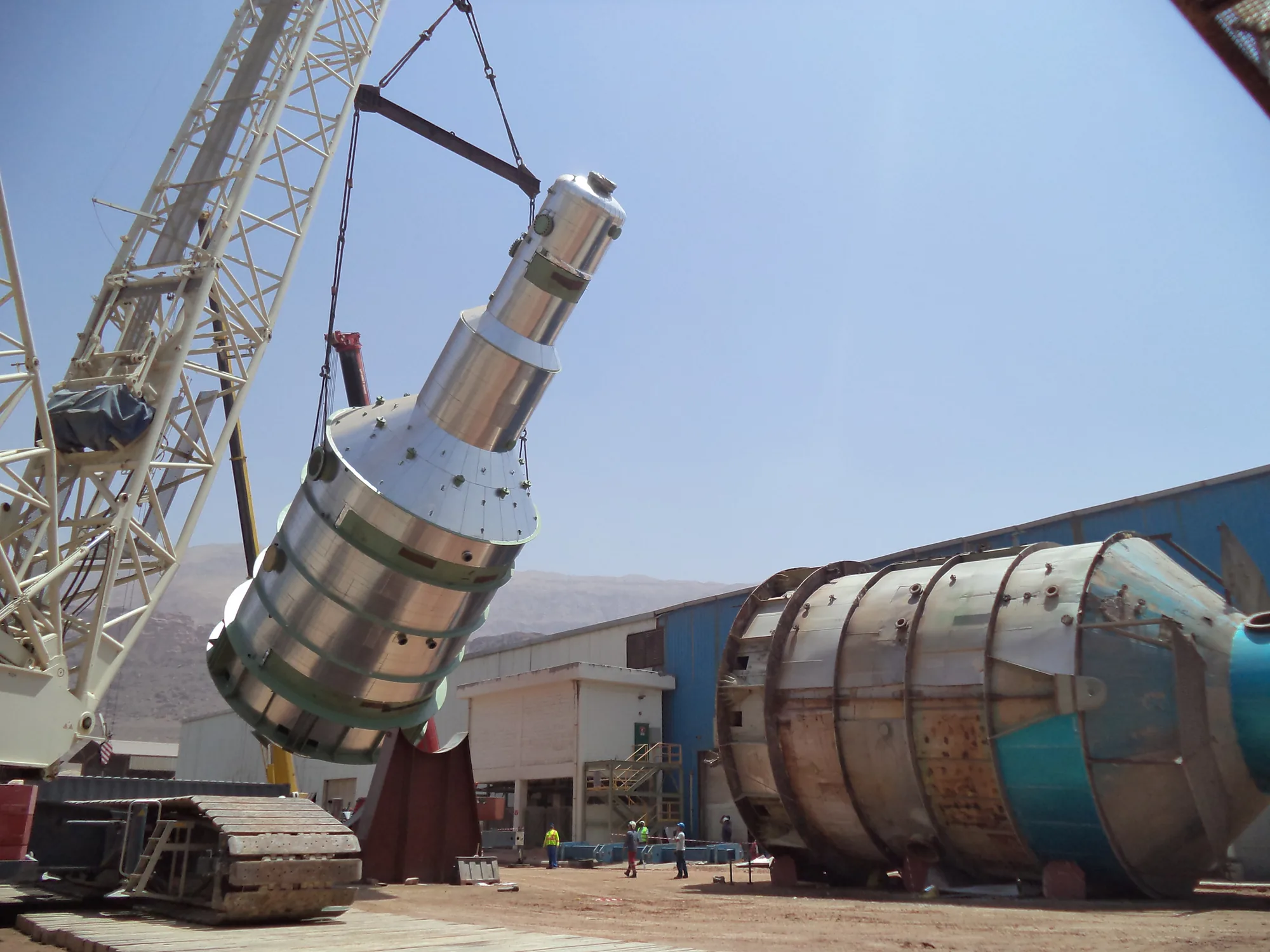 Crawler crane lifting a stainless steel crystalliser body into position